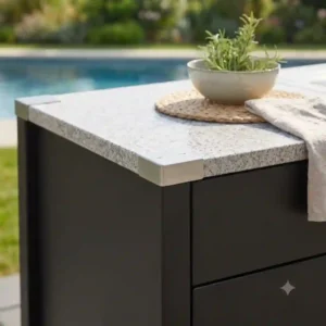 Close-up of the textured granite countertop and stainless steel details of the outdoor küchenmöbel design modern.